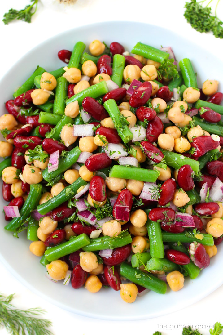 Overhead view of three bean salad tossed in a vinegar dressing with no refined sugar and no oil
