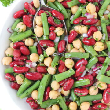 Three bean salad with oil-free vinegar dressing in a white bowl with spoon