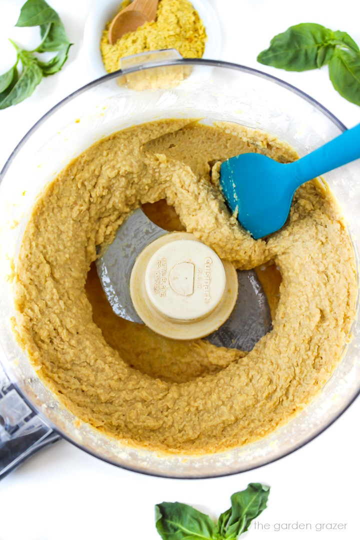 Overhead view of vegan chickpea almond flour ricotta cheese blended in a food processor