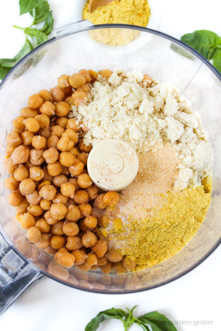 Overhead view of preparing vegan chickpea ricotta cheese ingredients in a food processor before blending