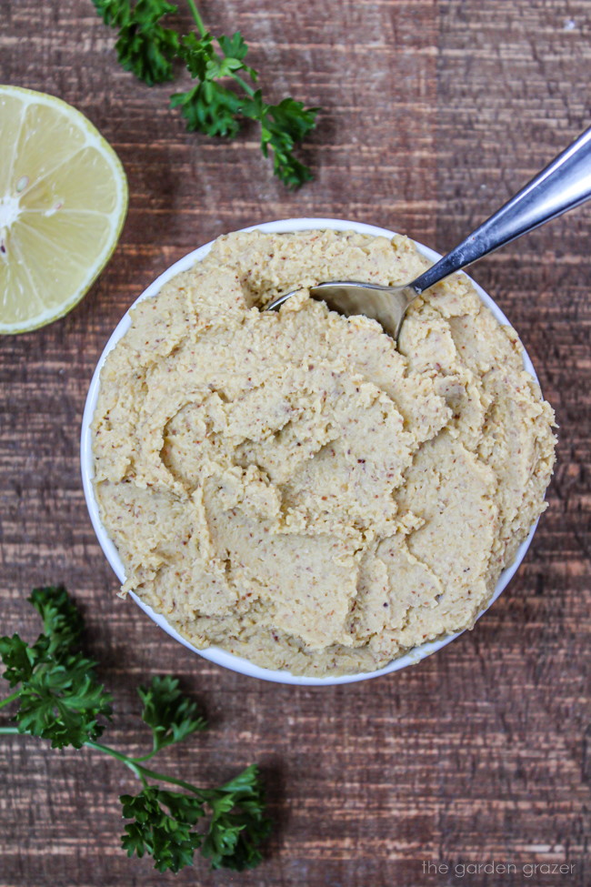 Vegan ricotta cheese in a small white bowl with spoon