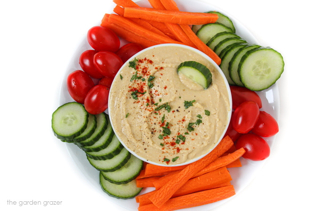 Vegetable tray with a bowl of oil-free hummus in the middle