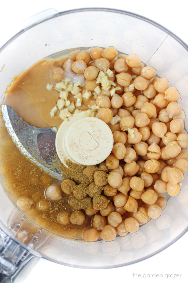 Garbanzo beans, tahini, garlic, lemon juice, and cumin in a food processor