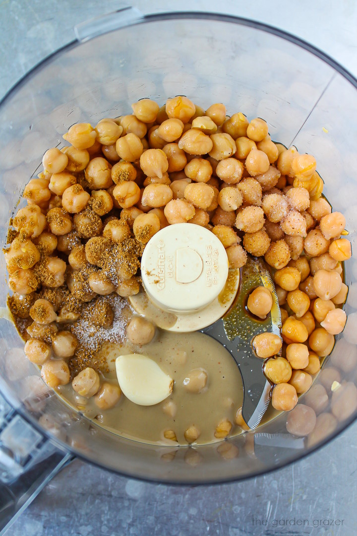 Overhead view of ingredients in a food processor before blending together