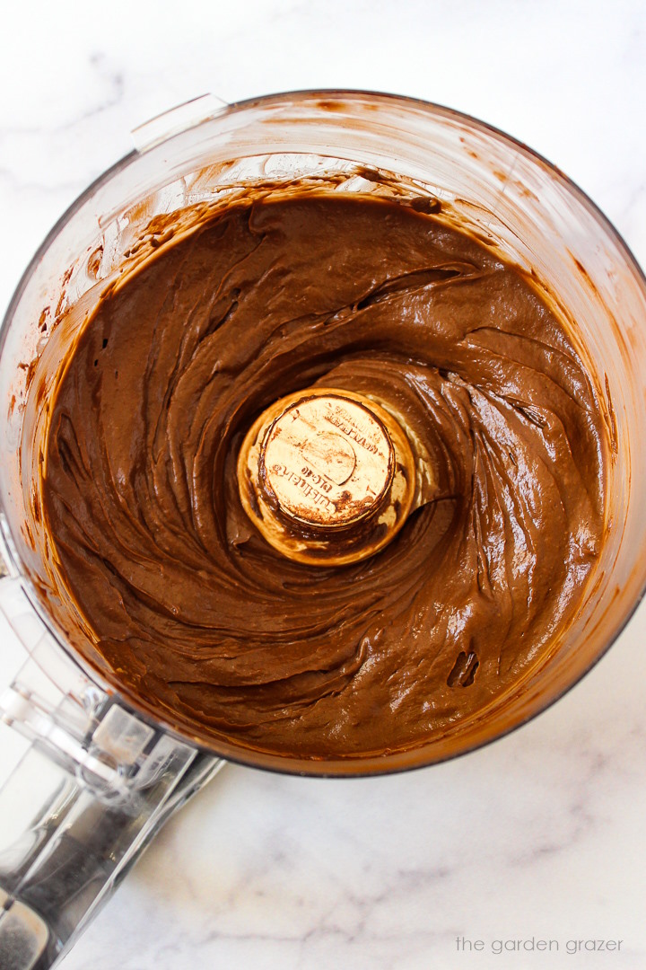 Overhead view of avocado chocolate mousse in a food processor after blending