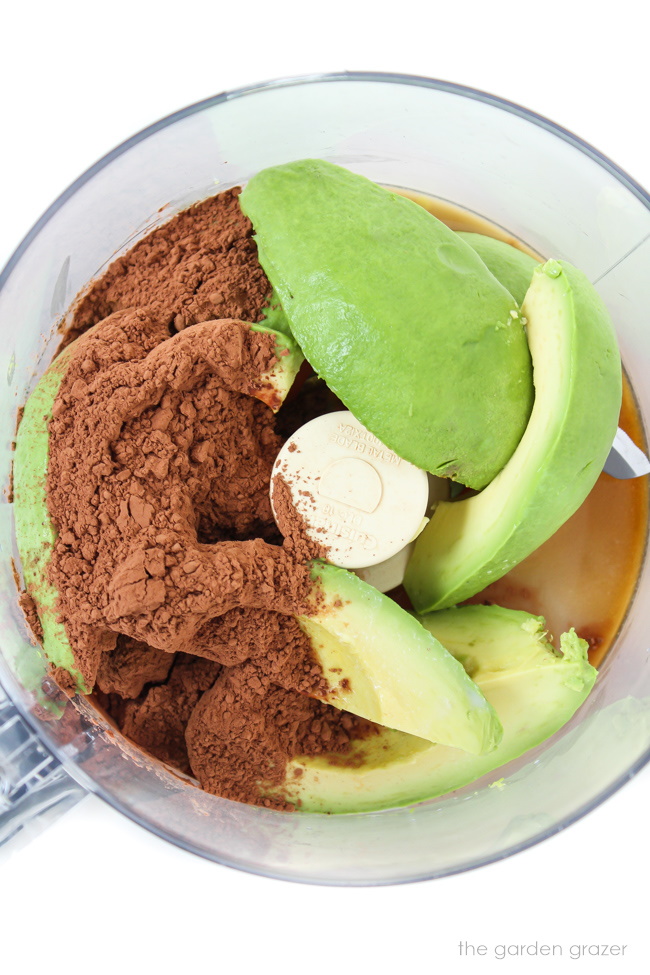 Ingredients for vegan avocado chocolate mousse in a food processor before blending