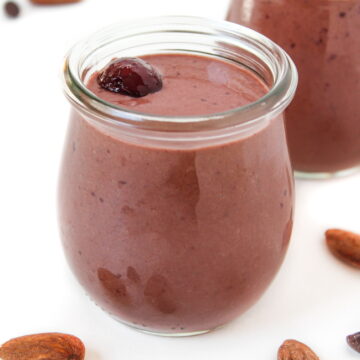 Vegan chocolate cherry almond smoothie in a small glass