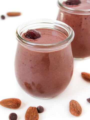 Vegan chocolate cherry almond smoothie in a small glass