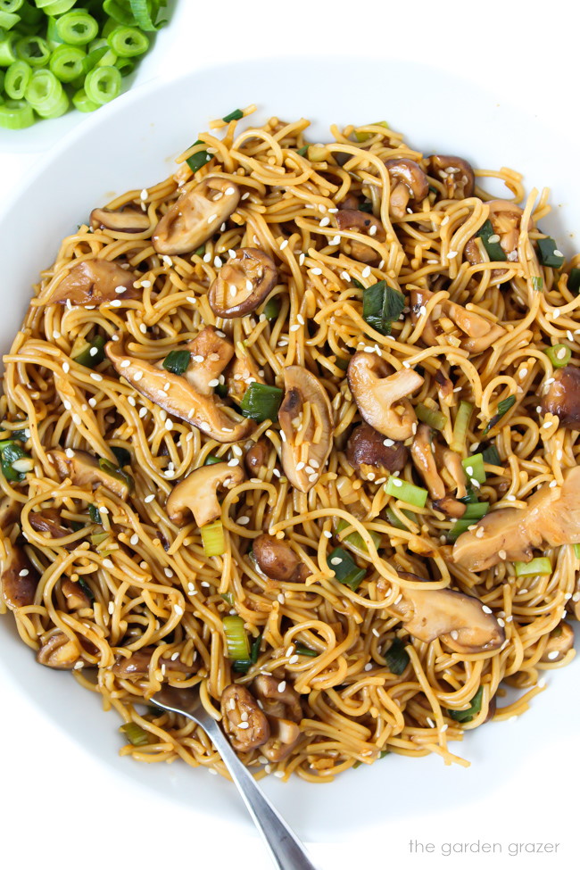 Vegan shiitake mushroom garlic noodles with green onions in a bowl