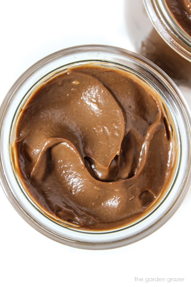 Overhead view of chocolate mousse in a small glass jar