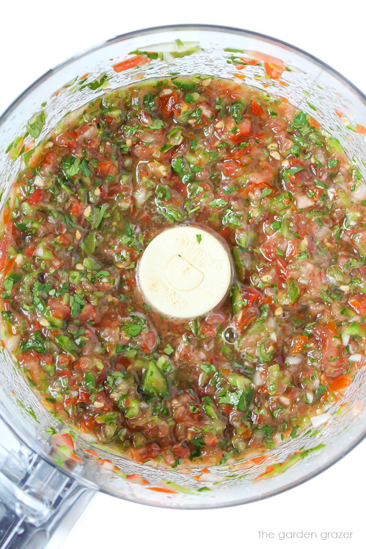 Overhead view of salsa blended together in a large food processor