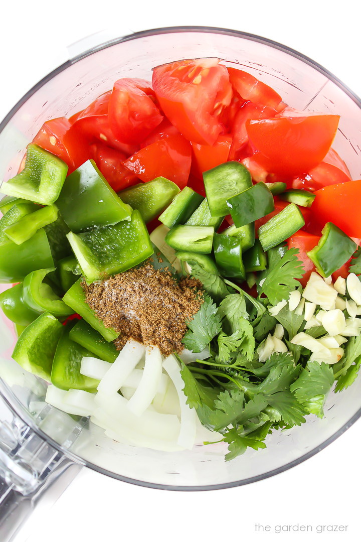 Chopped ingredients for garden salsa in a food processor before blending together