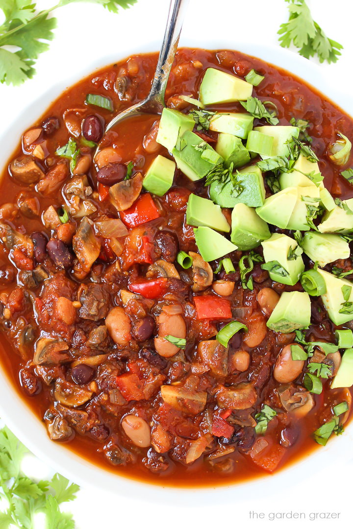 Close-up overhead view of a bowl of mushroom chili with spoon