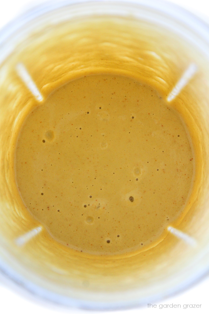 Overhead view of vegan cashew queso blended in a small blender