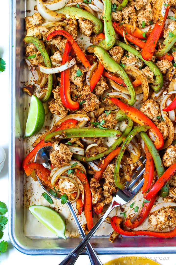 Overhead view of tofu fajitas cooking on a sheet pan