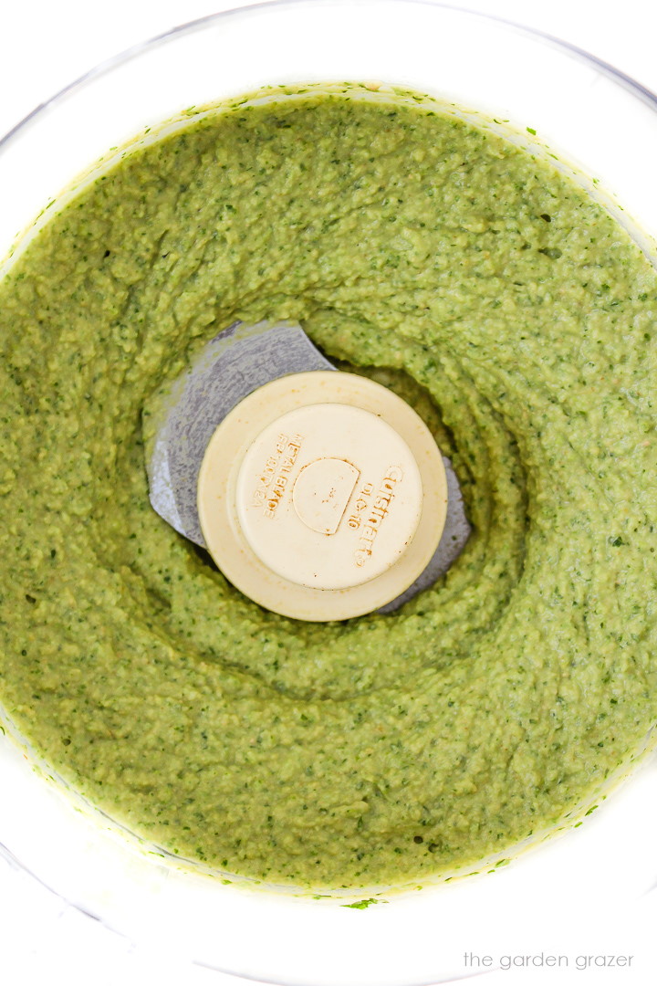 Overhead view of blended hummus in a food processor