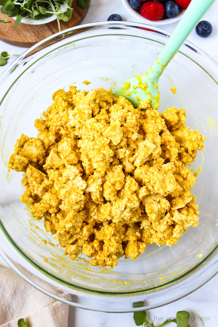 Preparing eggy tofu mixture in a glass bowl before cooking