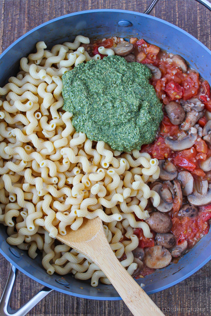 Preparing pasta ingredients in a large skillet before stirring together
