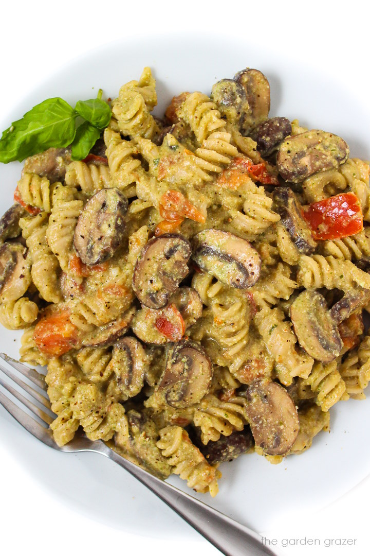 Overheat view of mushroom pesto pasta on a white plate