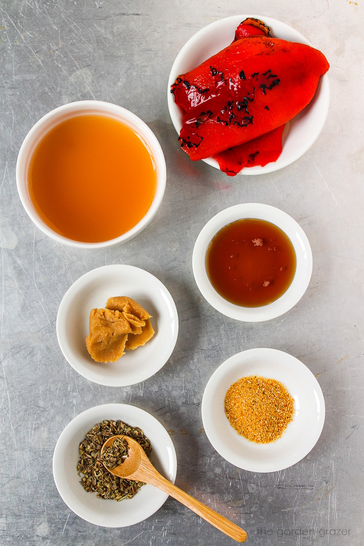 Bell pepper, vinegar, white miso, maple syrup, and spice ingredients laid out on a metal tray