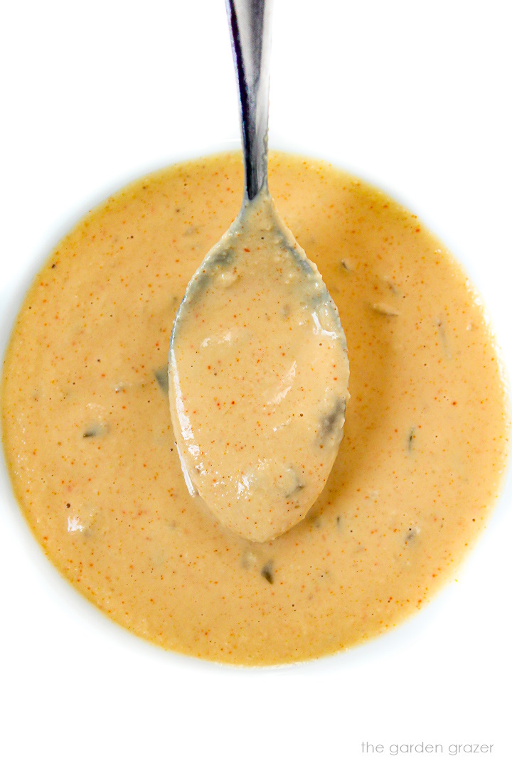 Vegan big mac burger sauce in a white bowl with spoon