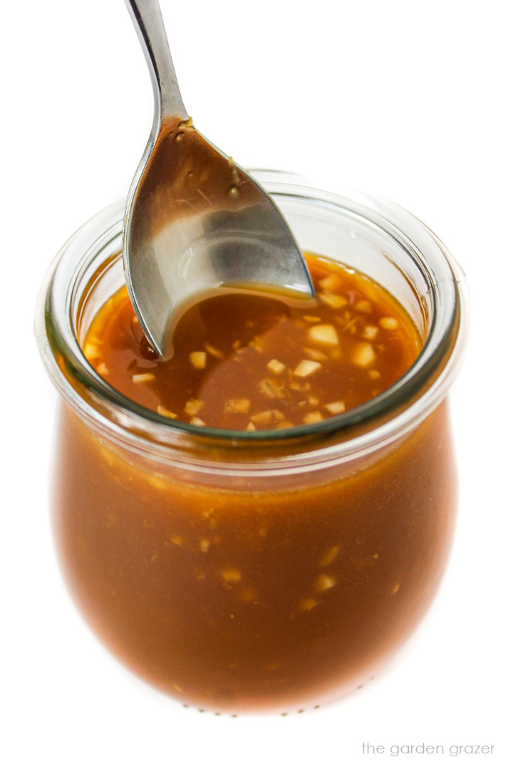 Vegan stir fry sauce with garlic and ginger in a small glass jar