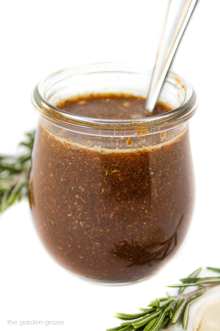 Oil-free maple balsamic dressing in a glass jar with spoon