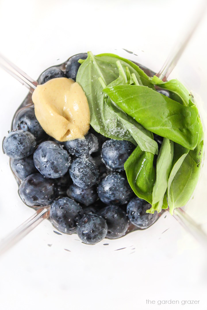 Ingredients for blueberry basil dressing in a blender before blending