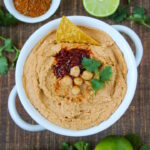 Chipotle taco hummus in a white serving bowl on a wooden table