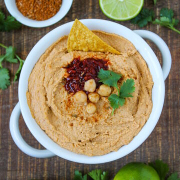 Chipotle taco hummus in a white serving bowl on a wooden table