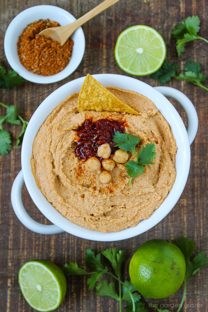 Chipotle taco hummus in a white serving bowl on a wooden table