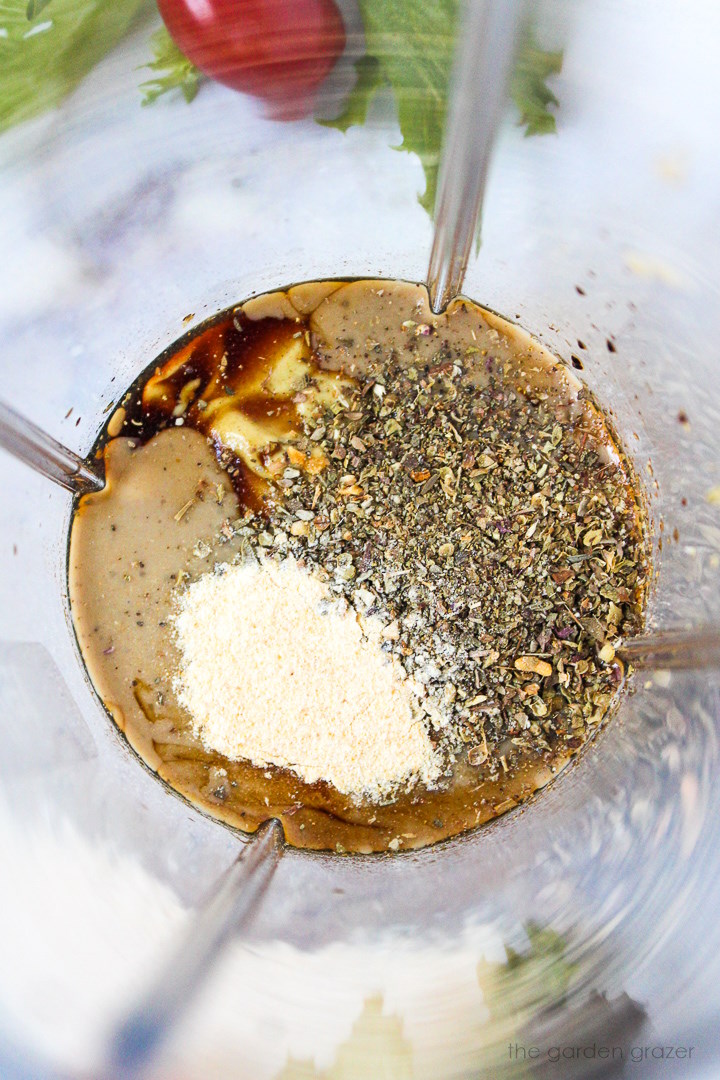 Overhead view of ingredients in a small blender cup before blending together