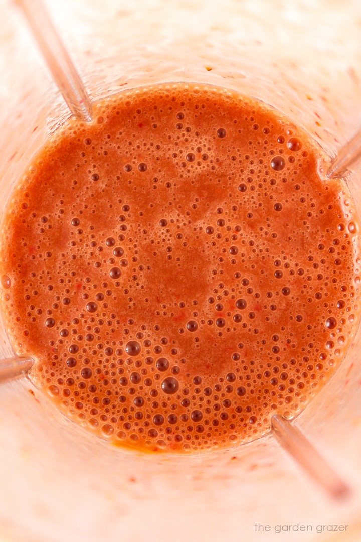Overhead view of strawberry balsamic dressing in a blender after blending