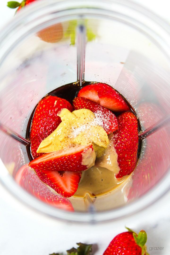 Overhead view of preparing ingredients in a blender cup before blending together