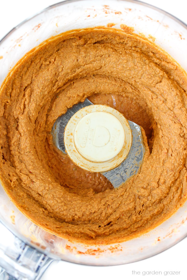 Overhead view of blended chipotle taco hummus in a food processor