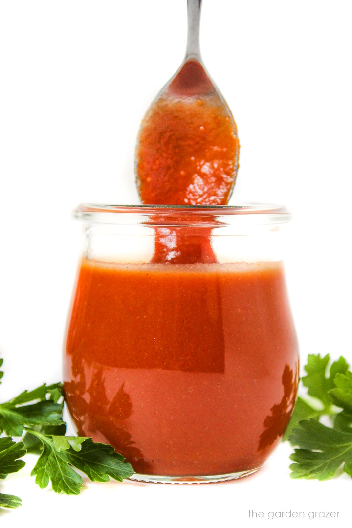 Oil-free vegan French Dressing in a small glass jar with serving spoon