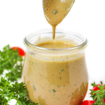 Vegan Italian dressing in a glass jar with serving spoon