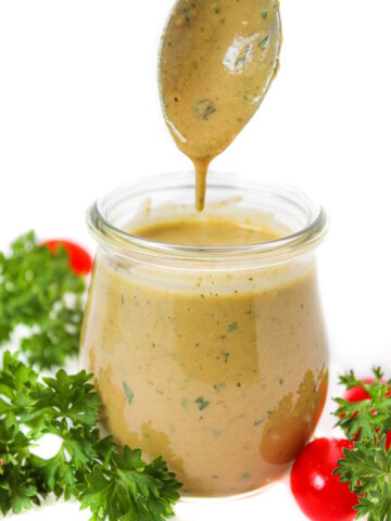 Vegan Italian dressing in a glass jar with serving spoon