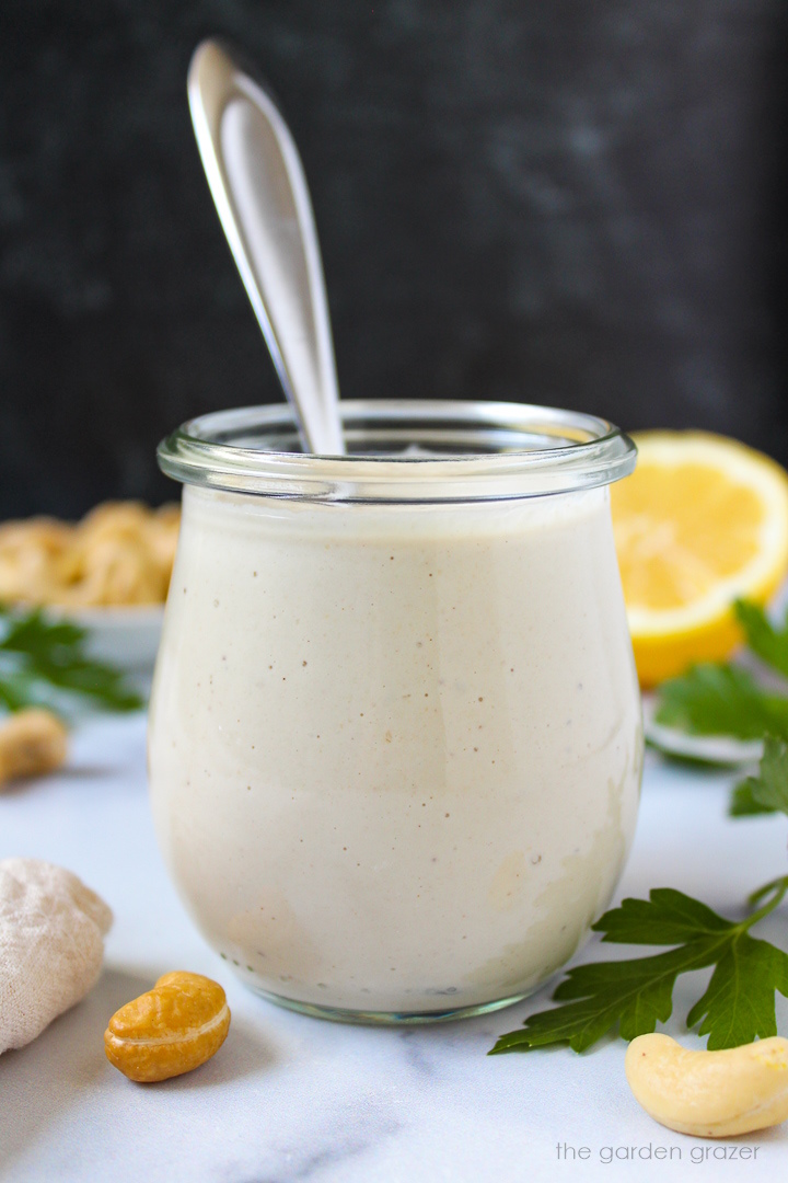 Vegan cashew mayo in a small jar with spoon