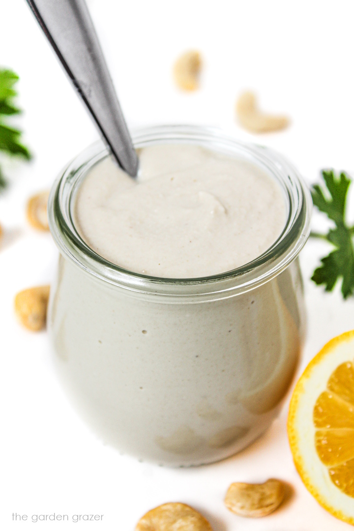 Vegan cashew mayo in a small jar with spoon