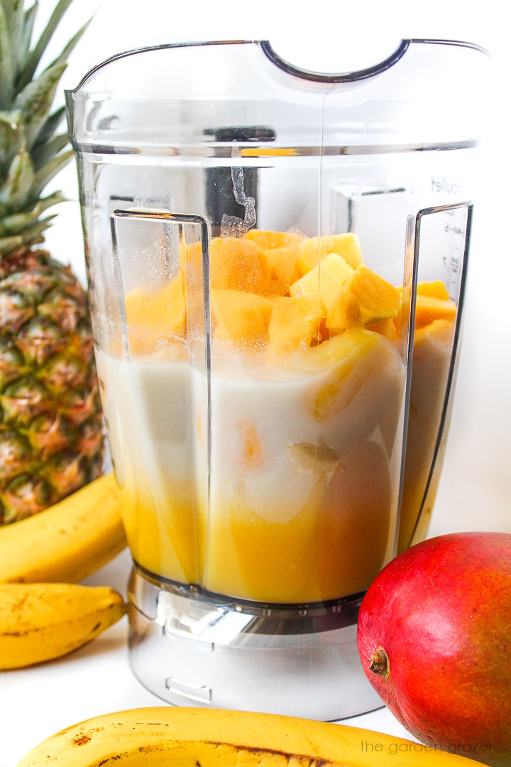 Smoothie ingredients in a large blender before blending together