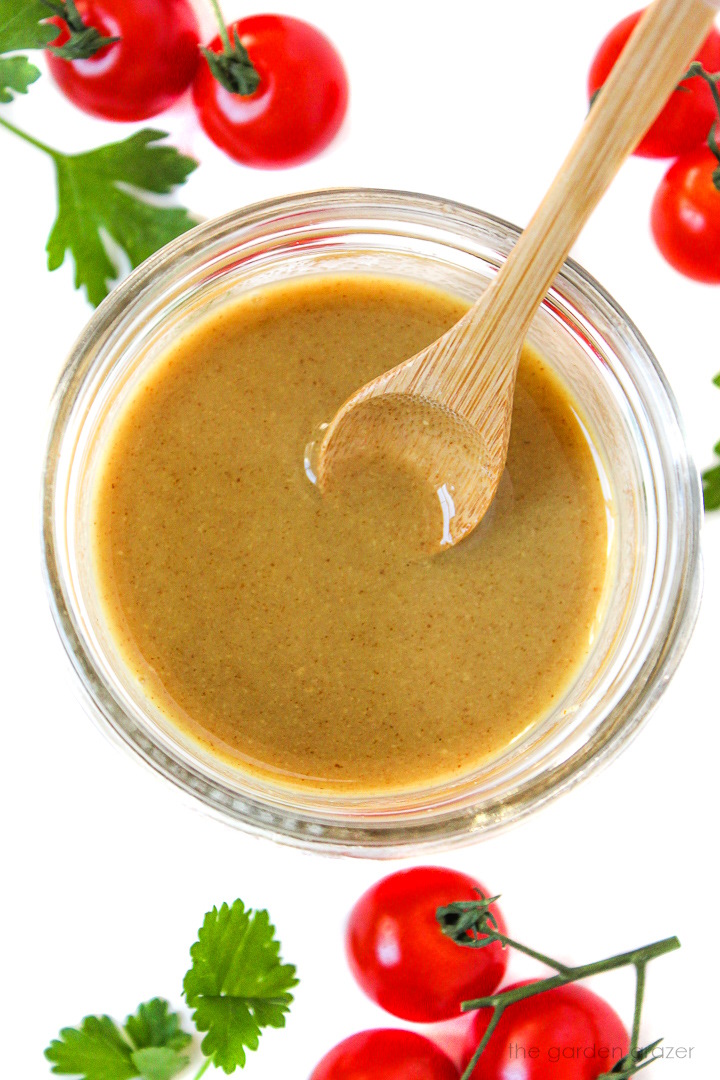Overhead view of preparing dressing in a small glass jar