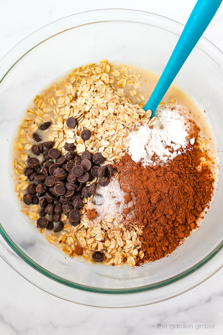 Overhead view of preparing ingredients in a glass bowl before mixing together