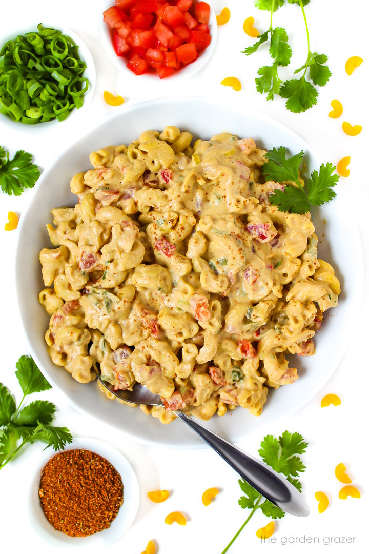 Vegan Mexican-style mac and cheese in a white bowl with spoon