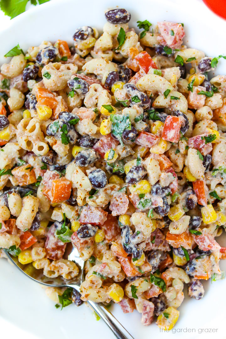 Overhead view of Mexican macaroni salad with creamy dressing on a white plate