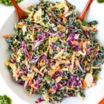 Overhead view of vegan kale and cabbage slaw in a white bowl