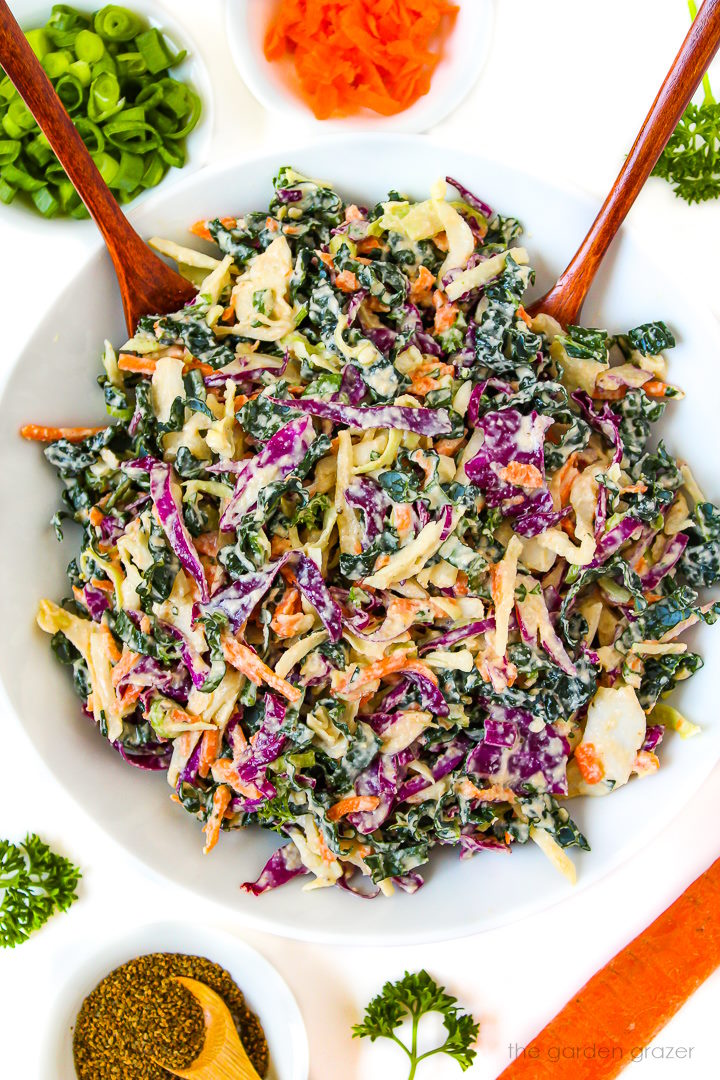 Overhead view of vegan kale and cabbage slaw in a white bowl