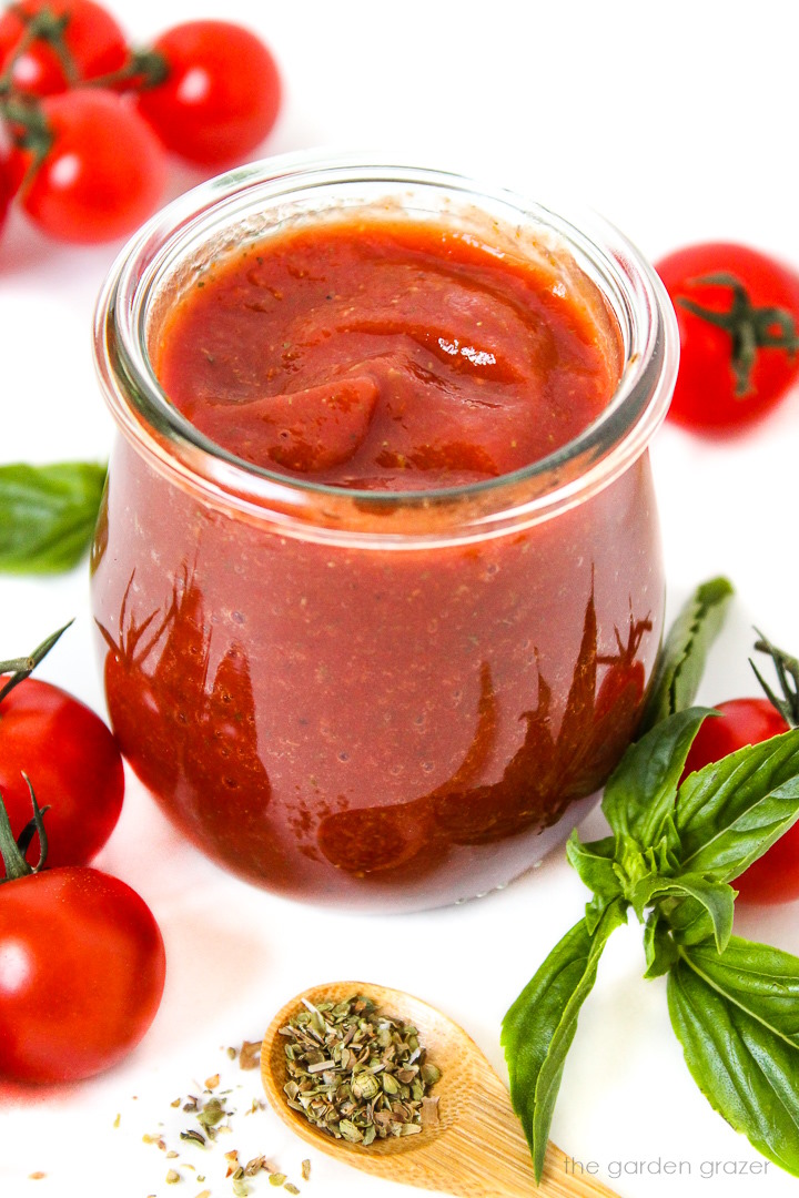 Prepared vegan pizza sauce in a small glass jar