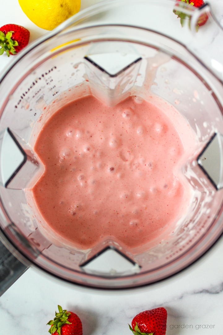 Overhead view of blended strawberry cream popsicle liquid during preparation
