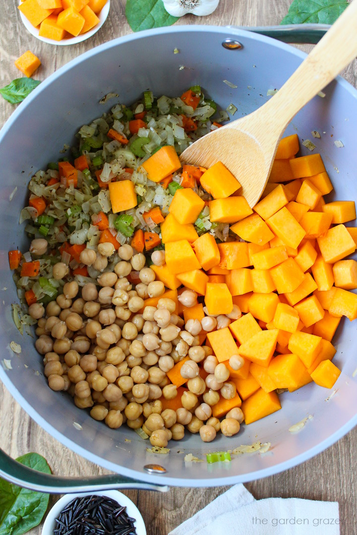 Overhead view of preparing butternut squash wild rice soup in a large pot